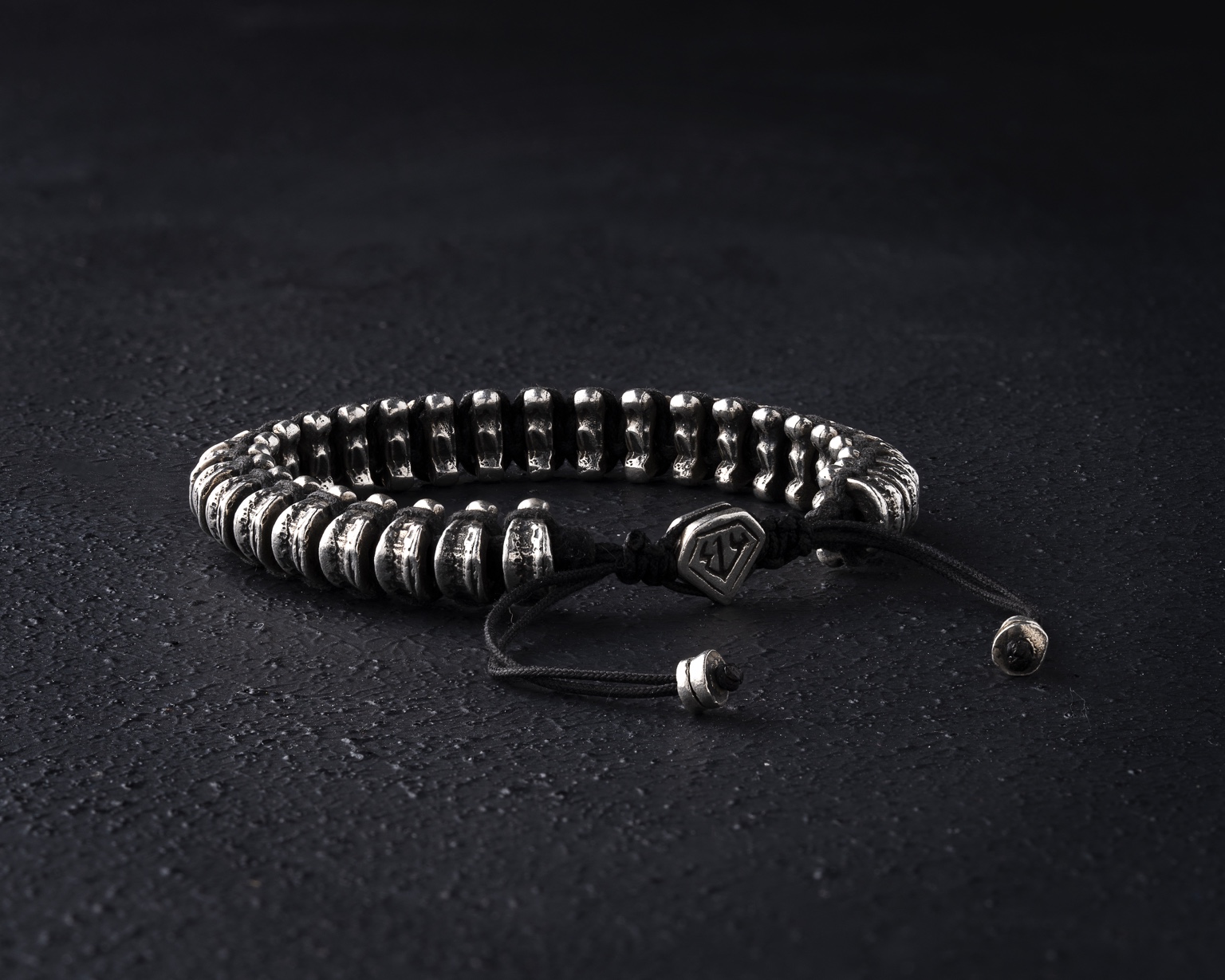 Silver bead bracelet with black cord