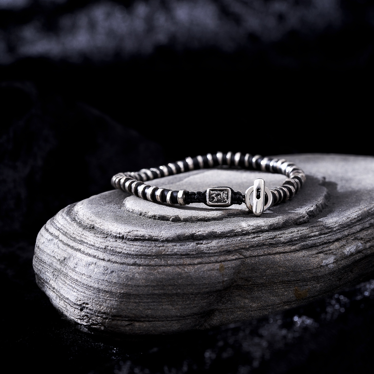 Black bracelet on stone